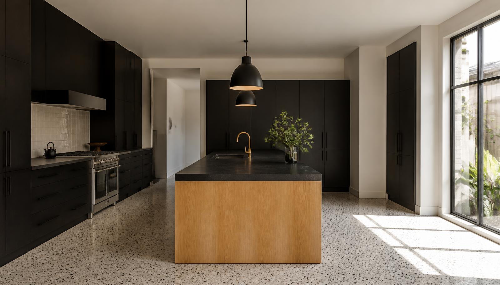 The same Bryanston kitchen completed, with an oak island, black stone counter and terrazzo floor