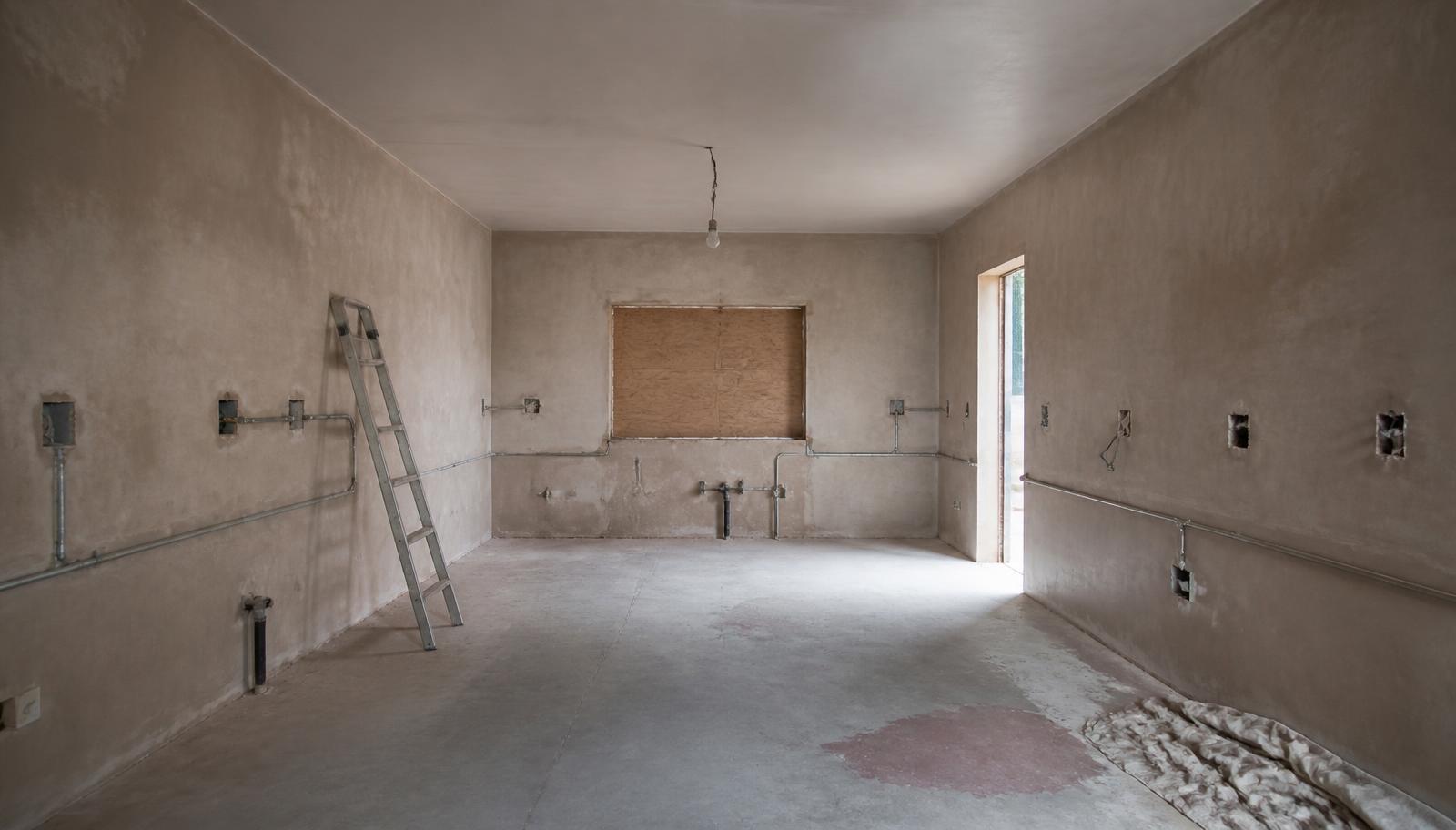 A Bryanston kitchen stripped back to bare plaster and screed before renovation